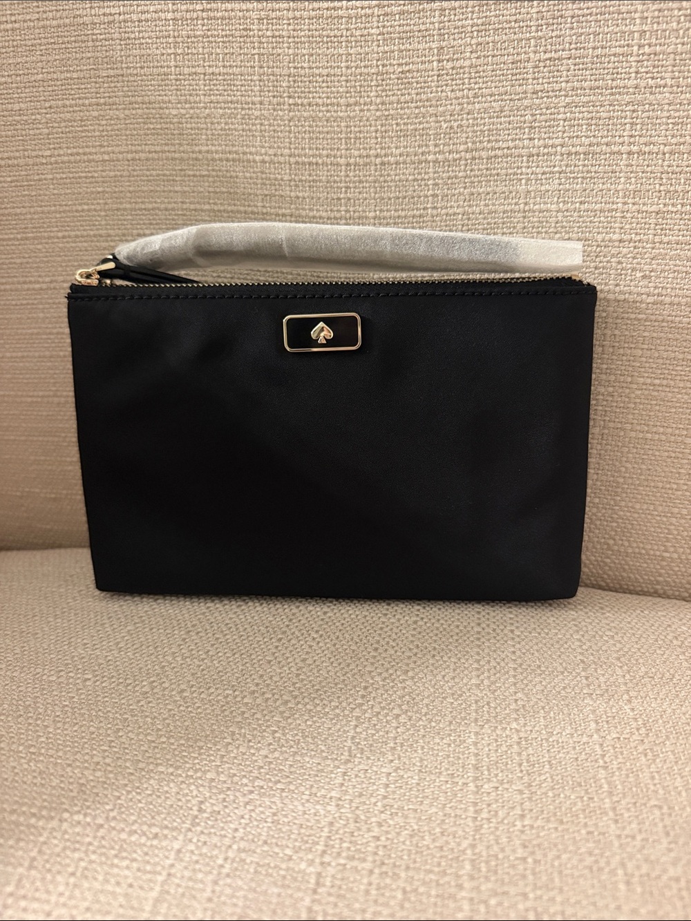 kate spade black wristlet pouch with gold spade logo